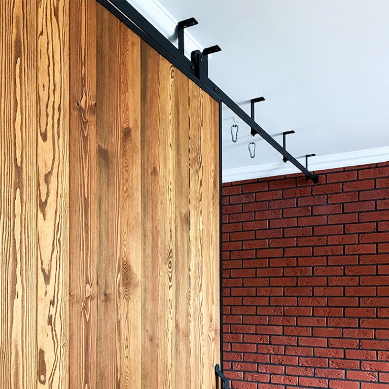 wooden sliding doors, sliding doors in a metal frame, brick on the wall