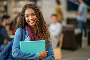 student with book and bag