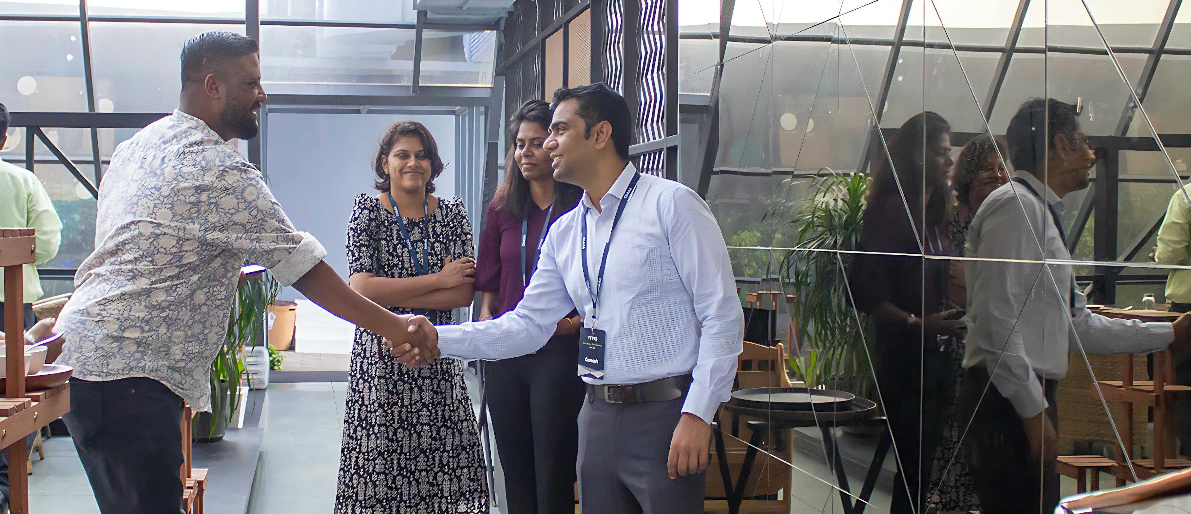 Ganesh Shankar (CEO) shaking hands with employee