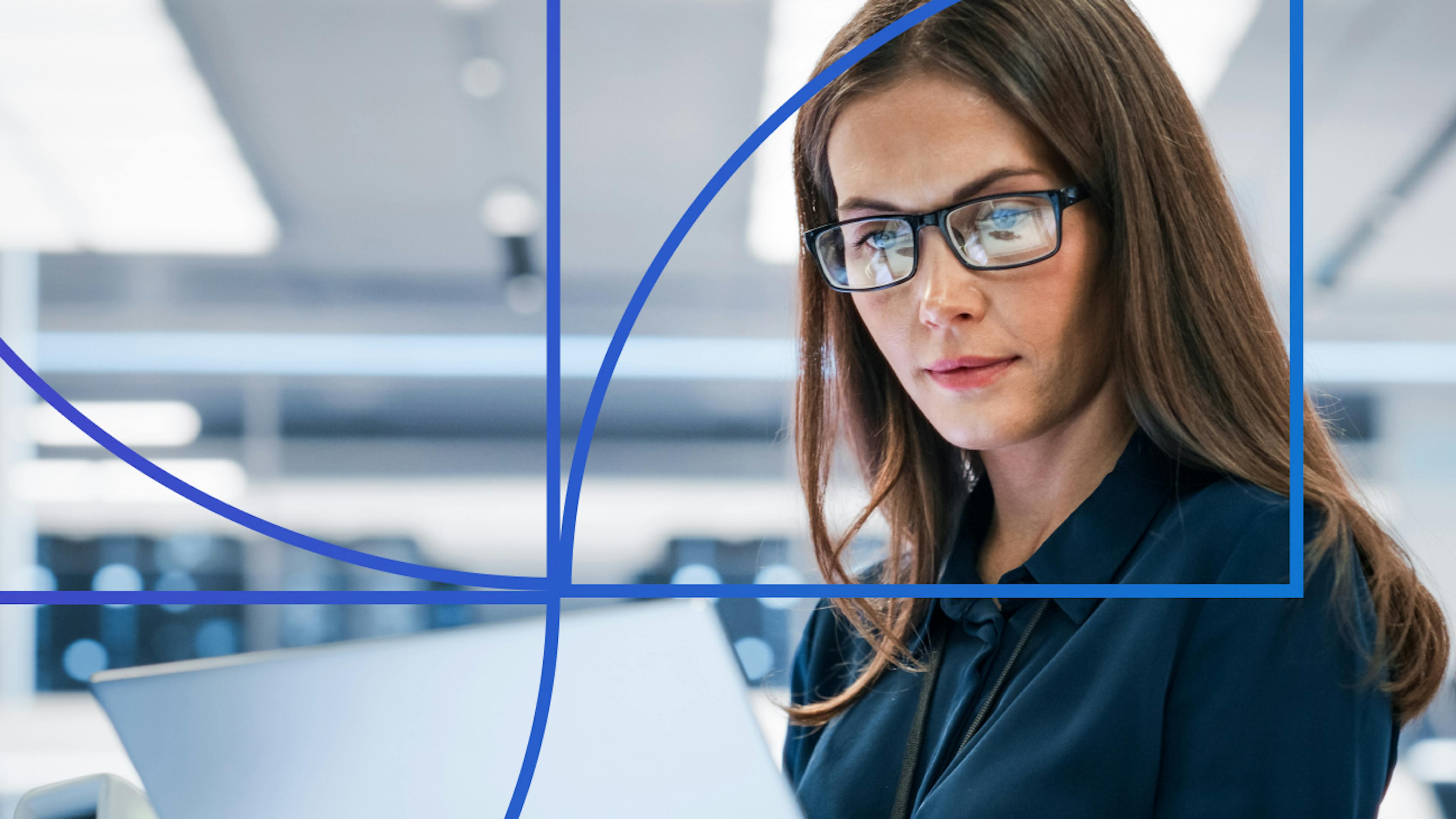 Woman with glasses looking at a laptop