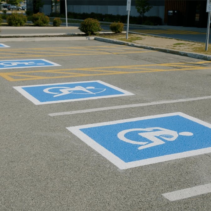 Ability signs painted on parking spaces.