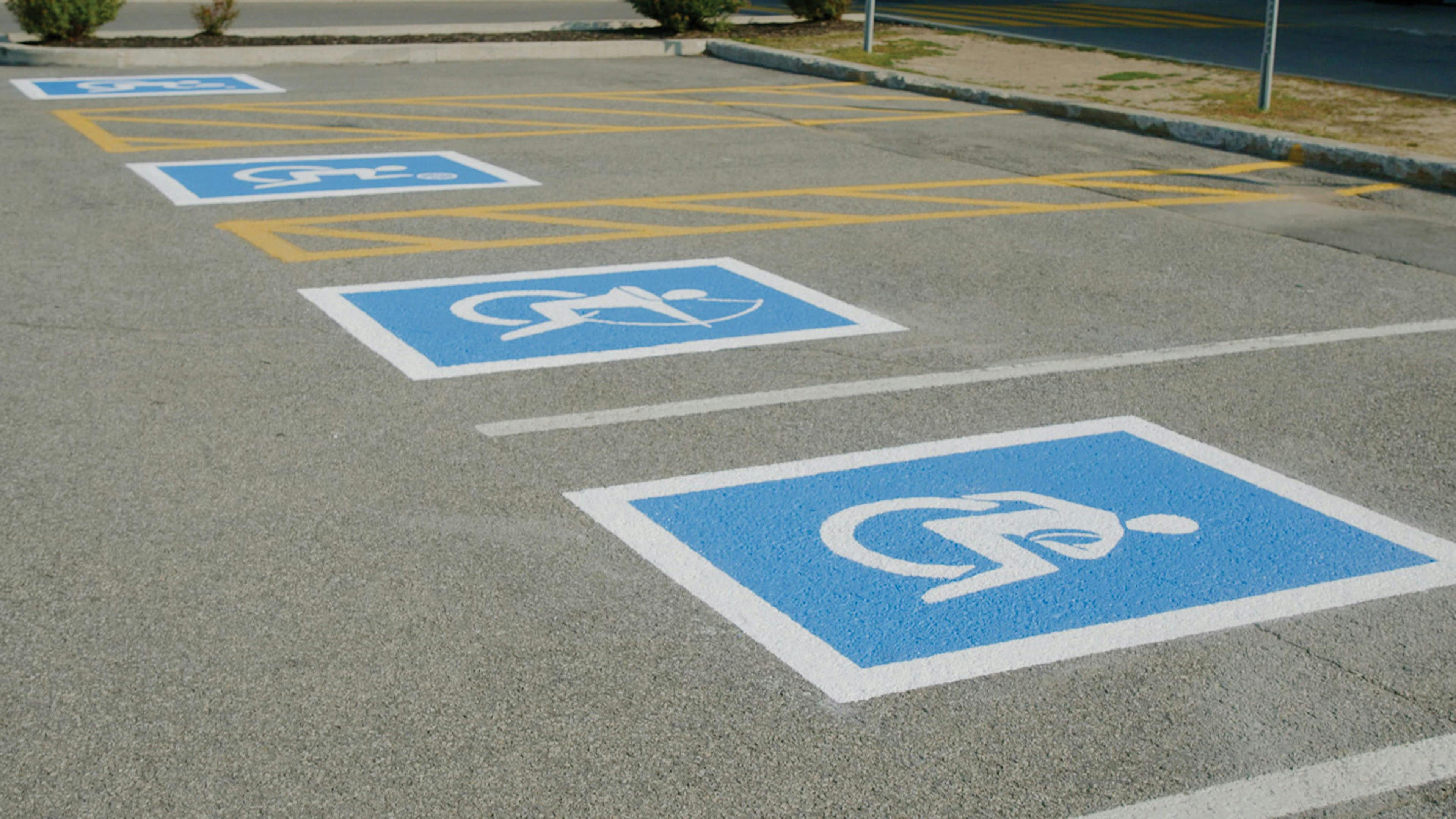 ability signs painted on parking spaces