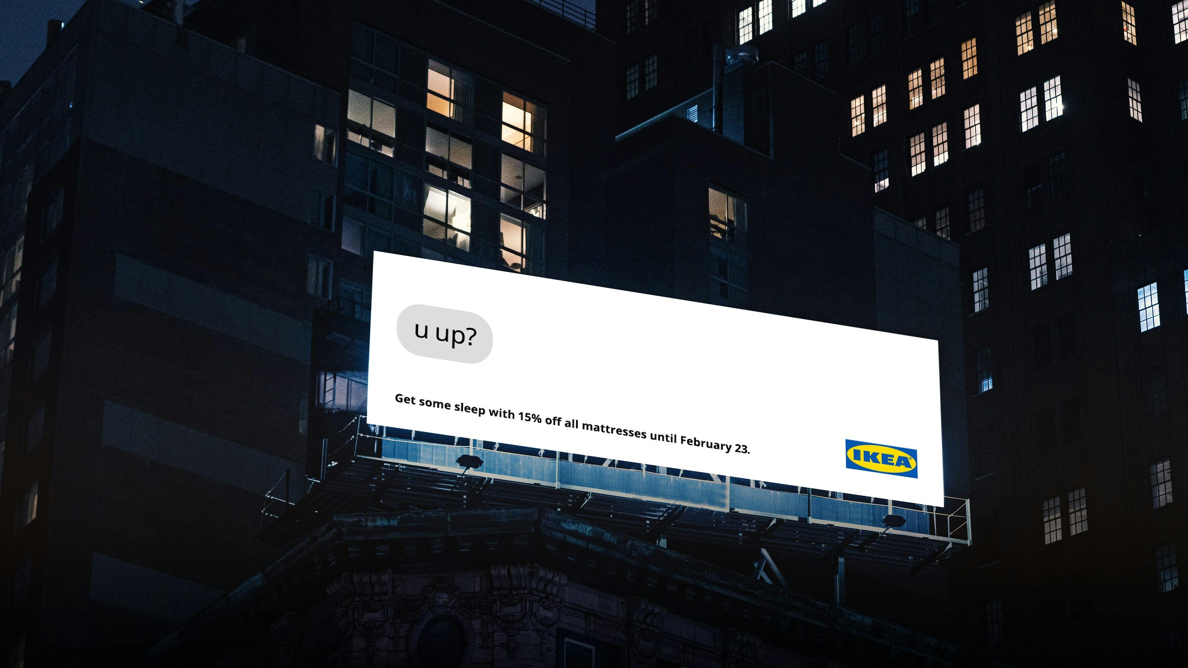 A downtown billboard with a text bubble saying, “u up?” and detailing an IKEA offer, “Get some sleep with 15% off mattresses until February 23.”