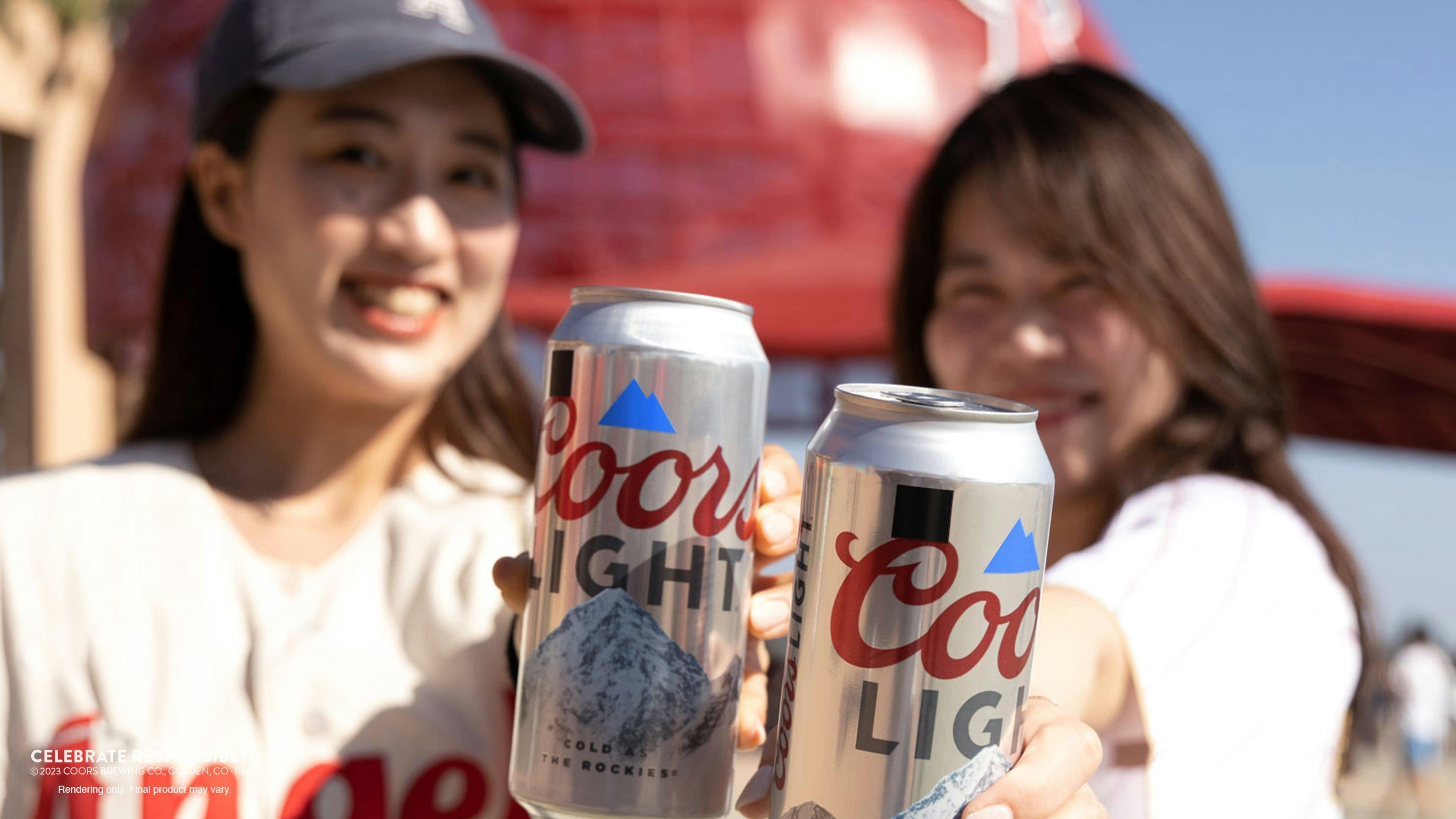 Two women, each holding a special-edition Coors Light can with a black square on the label, in front of Angel Stadium.