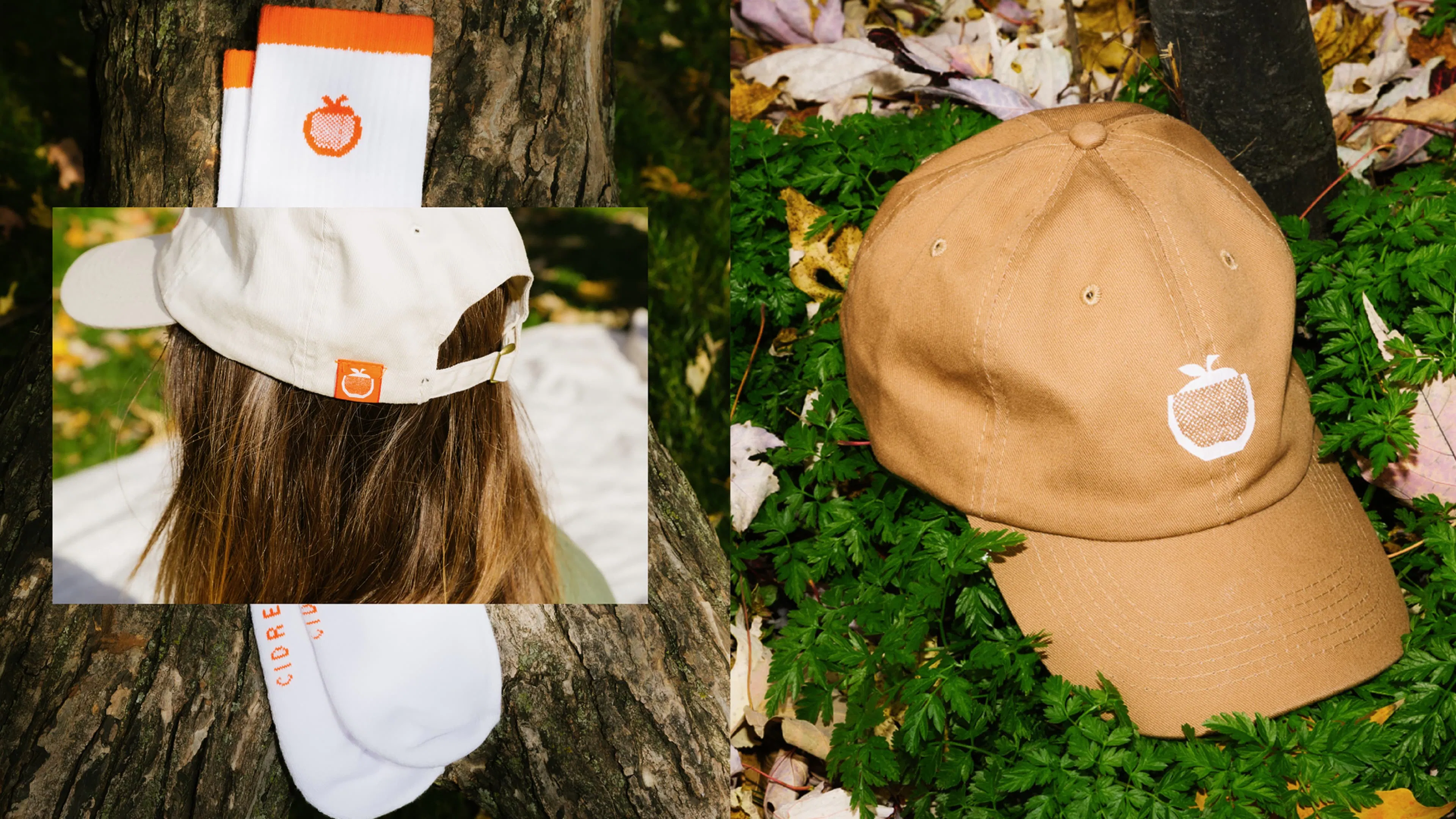 A white baseball cap and socks with orange accents and MILTON CIDERIE apple logos rest on a tree trunk. A tan baseball cap with a white MILTON CIDERIE apple logo rests on vibrant green foliage, surrounded by scattered autumn leaves in shades of yellow, red, and brown.