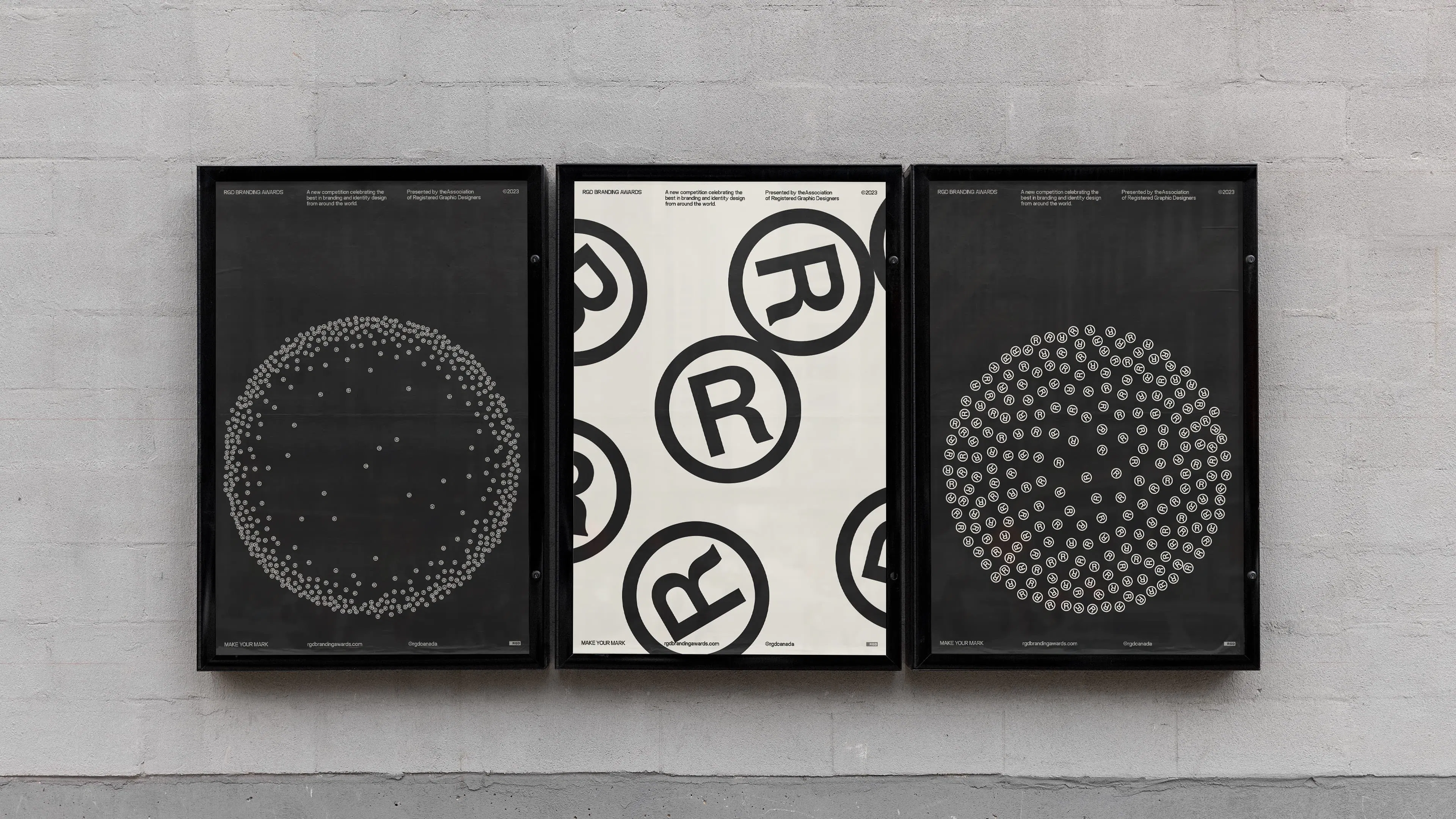 Three posters on a gray wall: Left and right posters feature circular patterns of small registered trademark symbols on dark backgrounds; the center shows large registered trademark symbols on white.