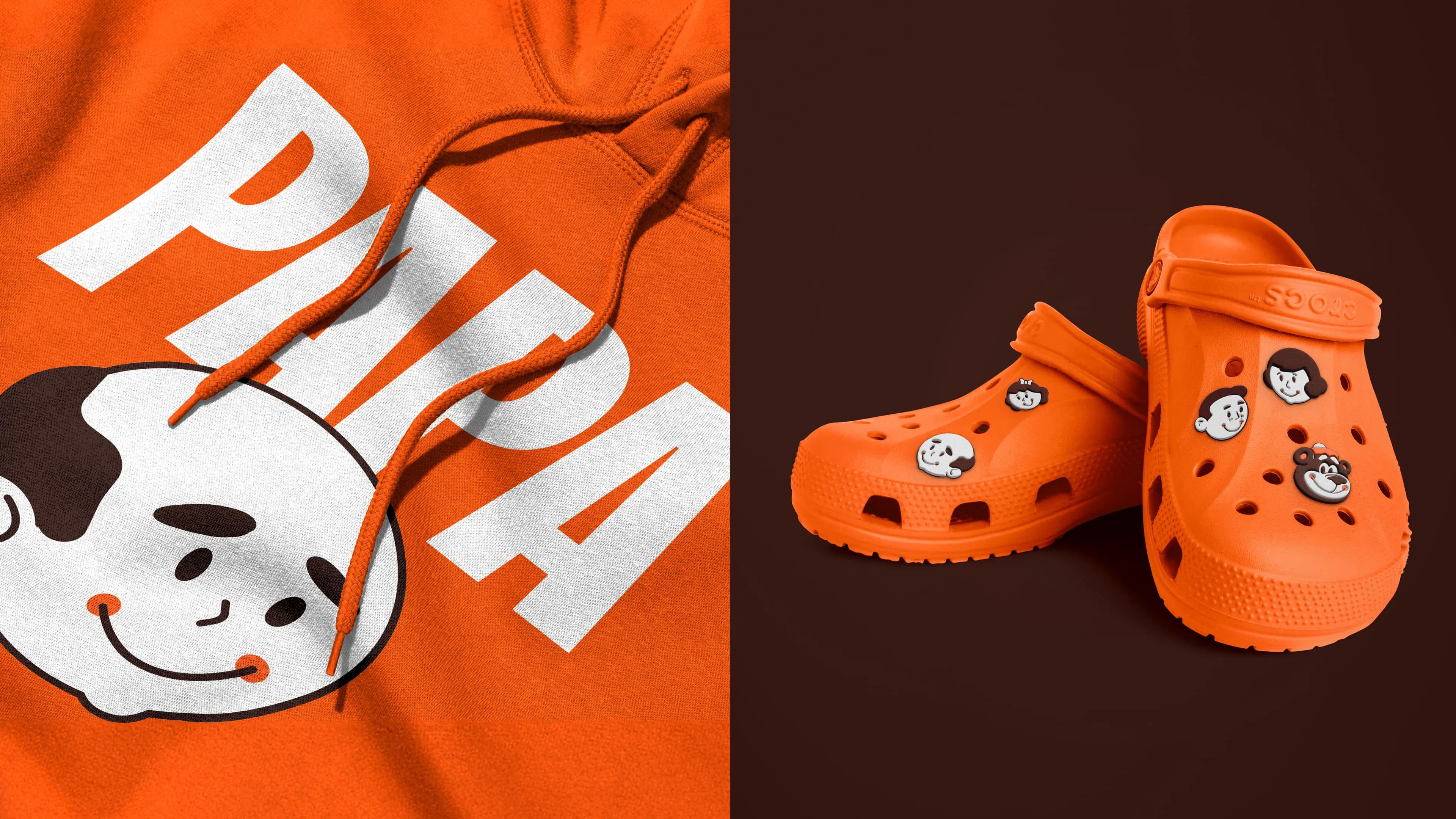 Bright orange hoodie and clogs with cartoon face designs. Hoodie shows a smiling face and bold 'PAPA' text; clogs have cartoon face charms.