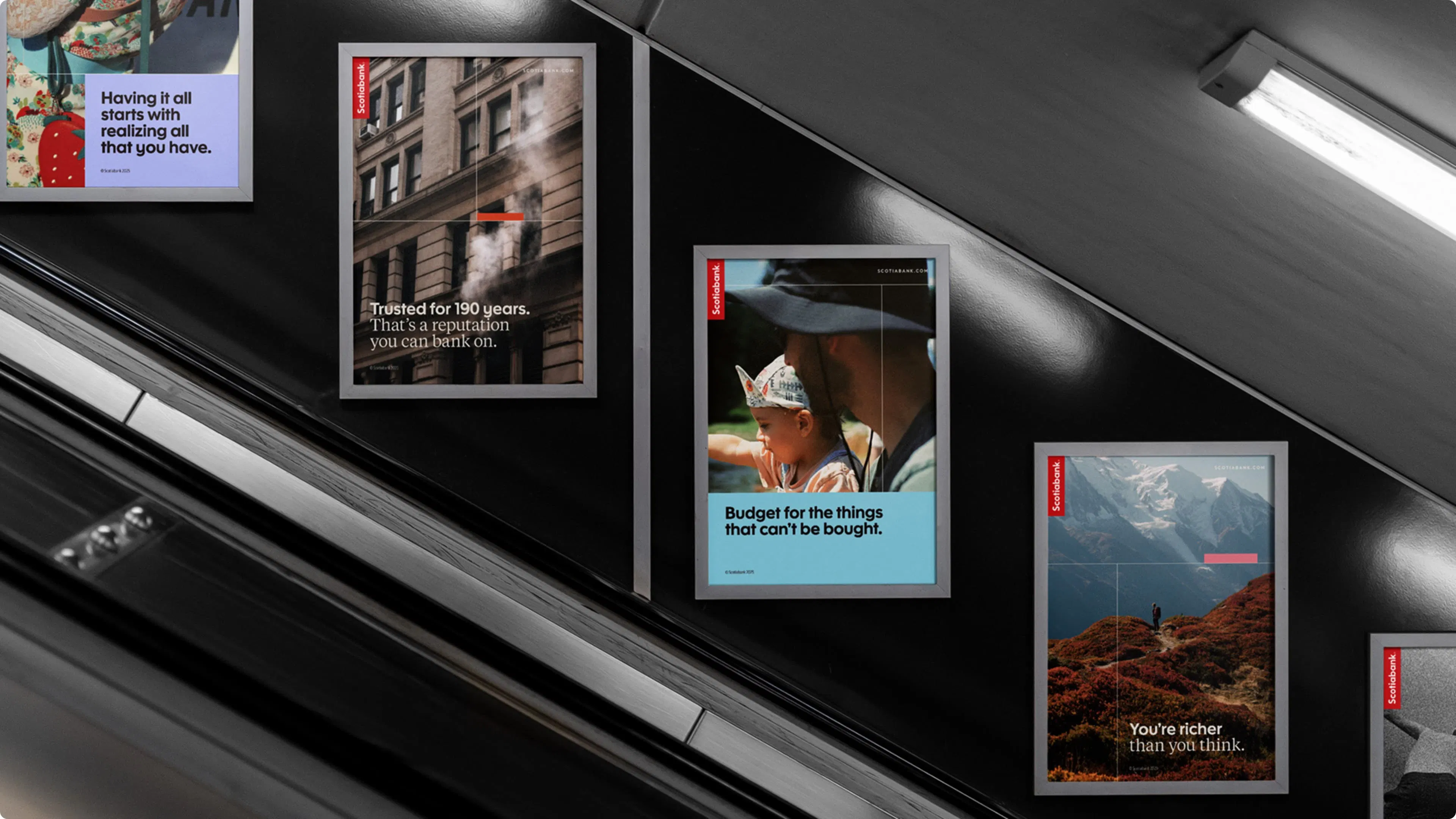 Subway escalator wall with five posters featuring motivational quotes. The vibrant images and text create an inspiring and uplifting atmosphere.