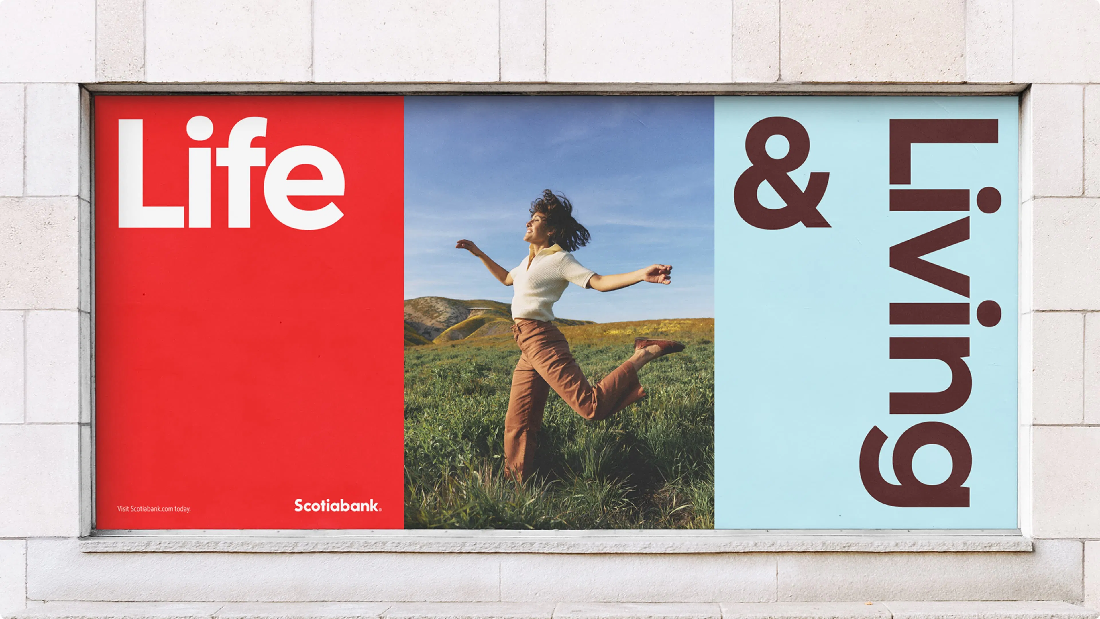 A vibrant advertisement featuring a joyful person leaping in a grassy meadow under a clear sky, flanked by bold text "Life" and "Living" in red and blue.
