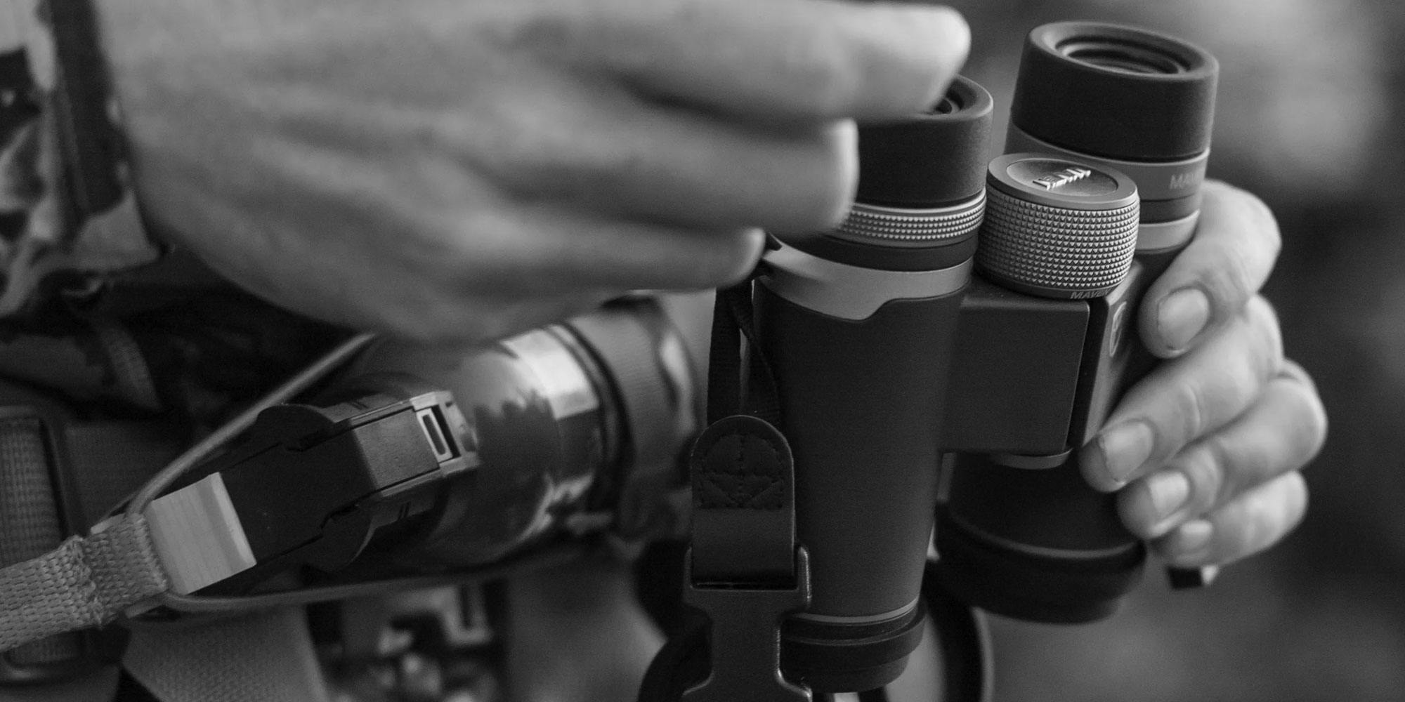 Outdoorsman holding Maven binoculars