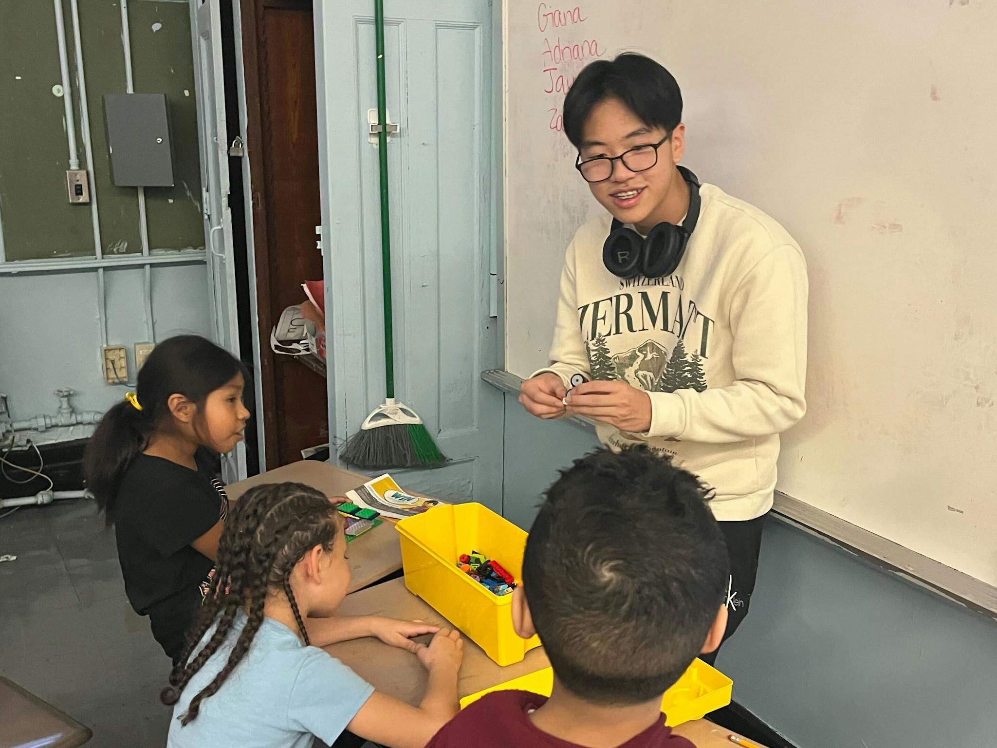 student volunteer smiling at students