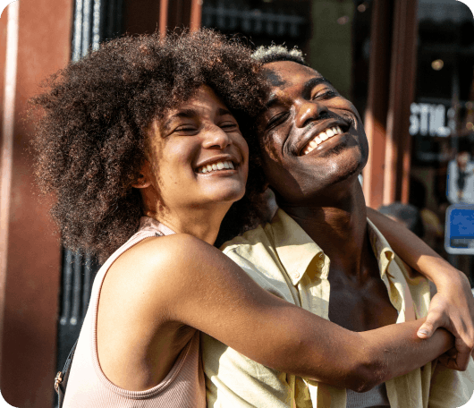 two people smiling and hugging