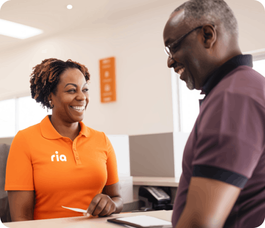 person picking up cash at a Ria store