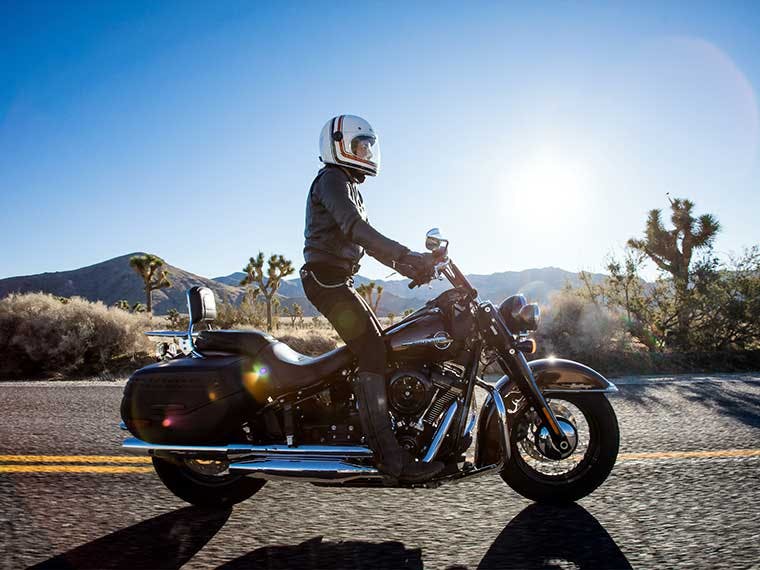 Riding Route 66 on a Harley-Davidson motorcycle.