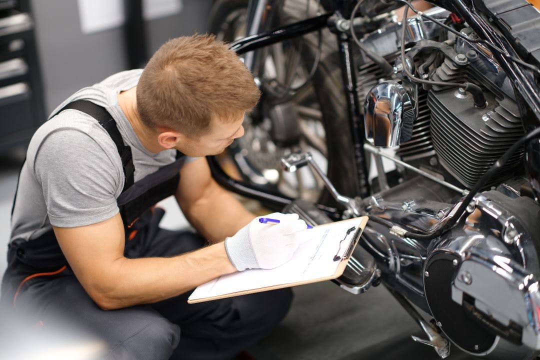 motorcycle mechanic going through motorcycle maintenance checklist your motorcycle checklist guide