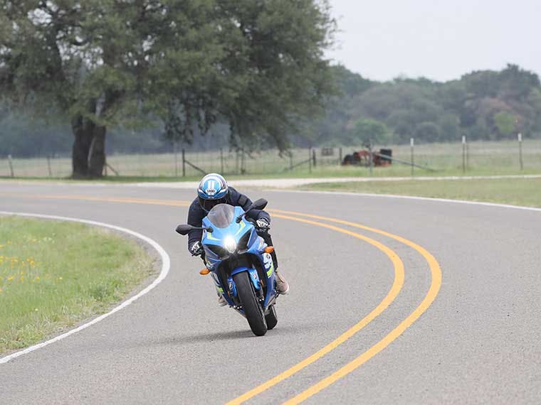 Man riding a rented Suzuki motorcycle near Austin, Texas.