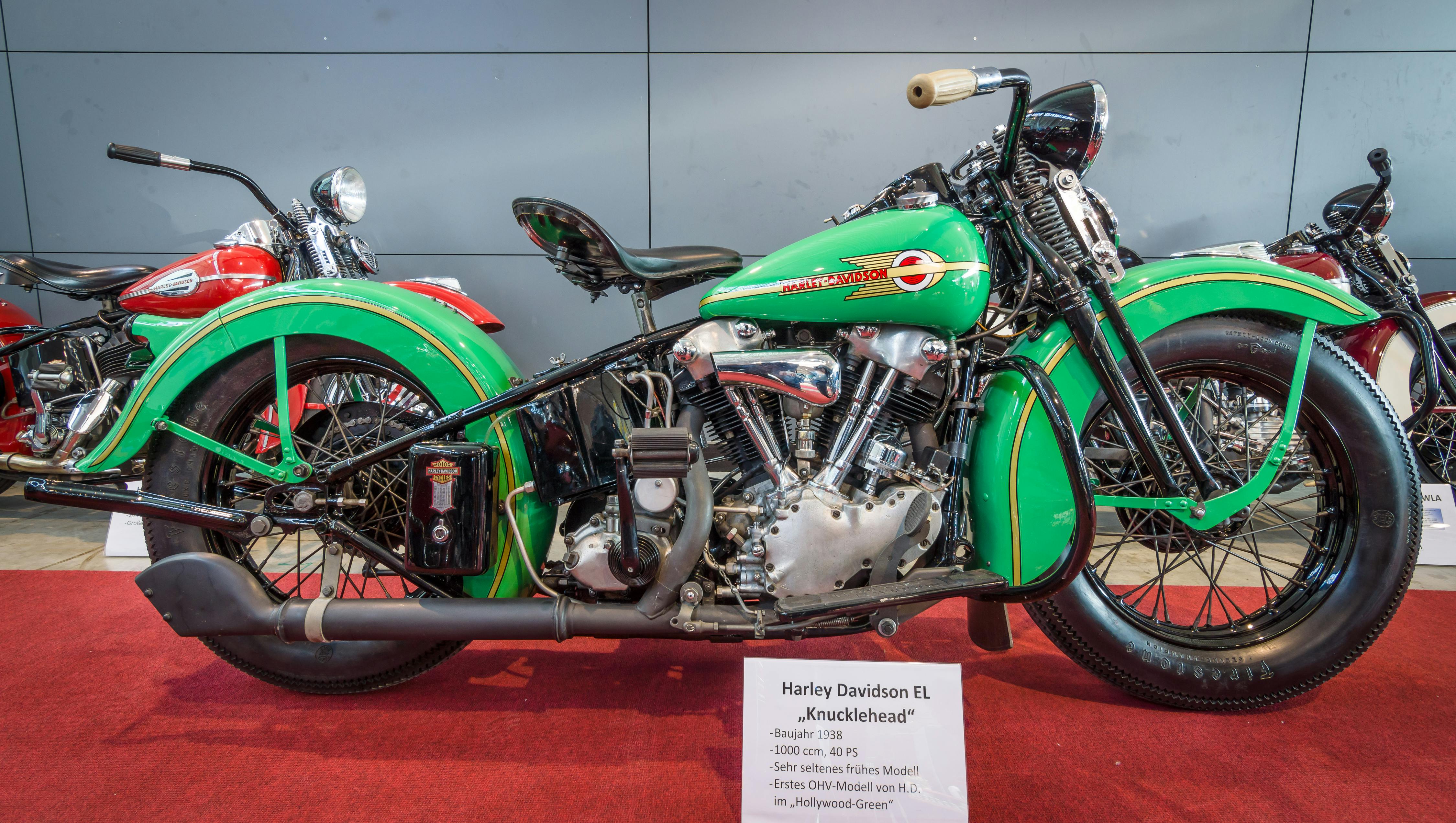 picture of a green Harley Davidson Knucklehead motorcycle on display at an indoor show