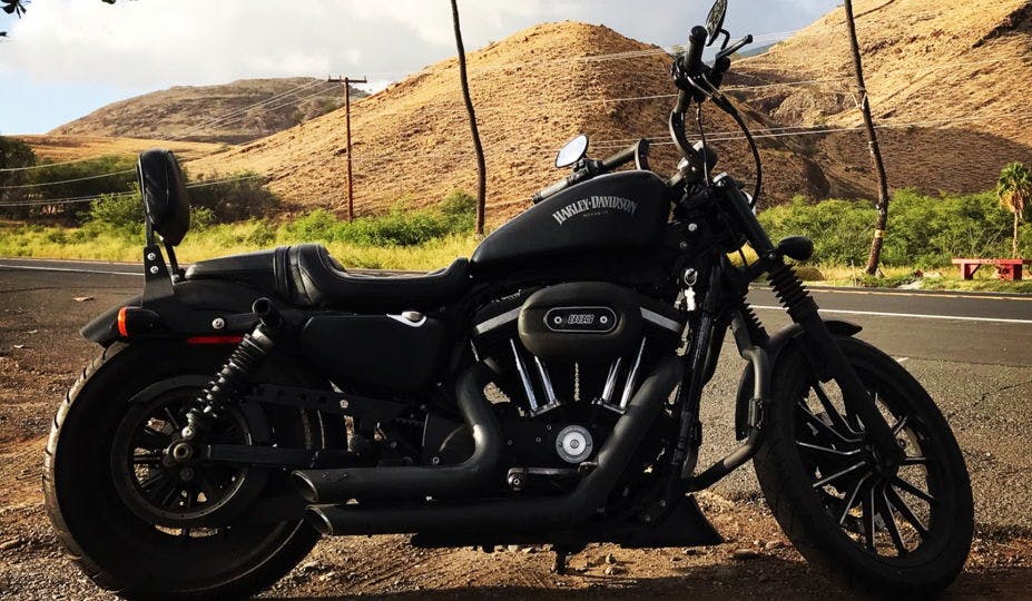 black Harley Davidson motorcycle parked on a road in Hawaii