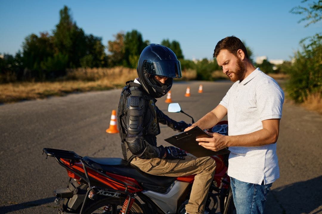 picture of a motorcycle rider and instructor at a motorcycle safety course