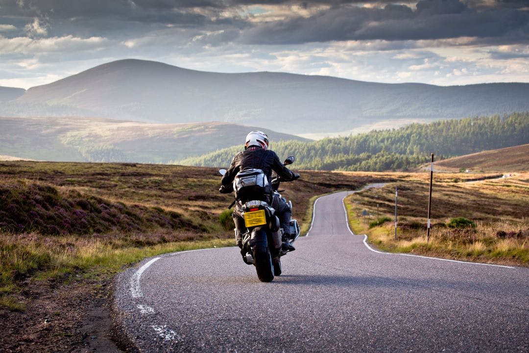 picture of a motorcycle rider on a curvy scenic road which bmw is best for touring and long rides