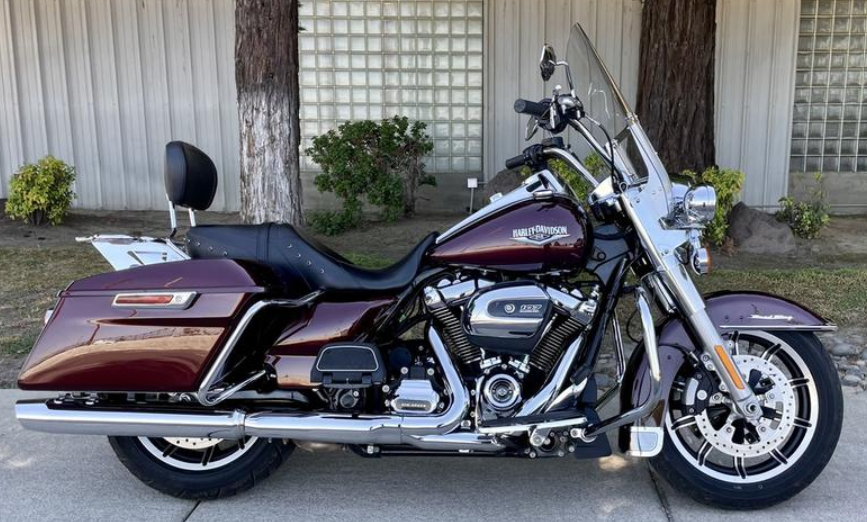 picture of a maroon Harley FLHR Road King parked in front of a building