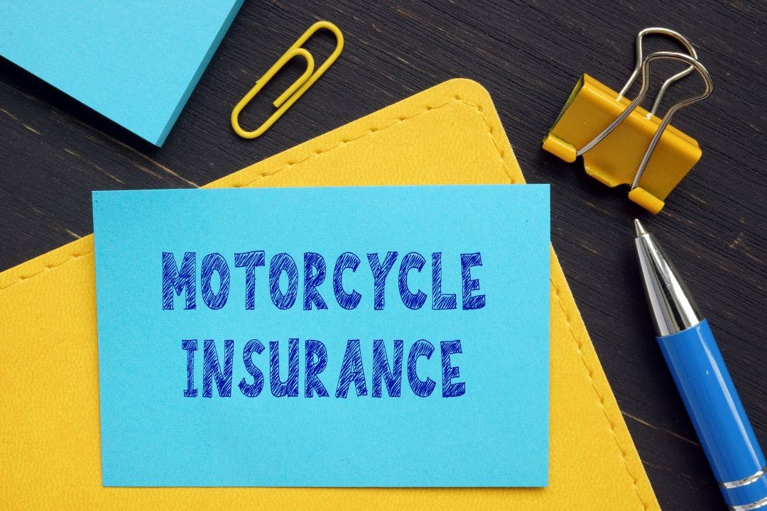 Business concept about MOTORCYCLE INSURANCE with inscription on the bank form Riders Share Now Helps You Save on Motorcycle Insurance