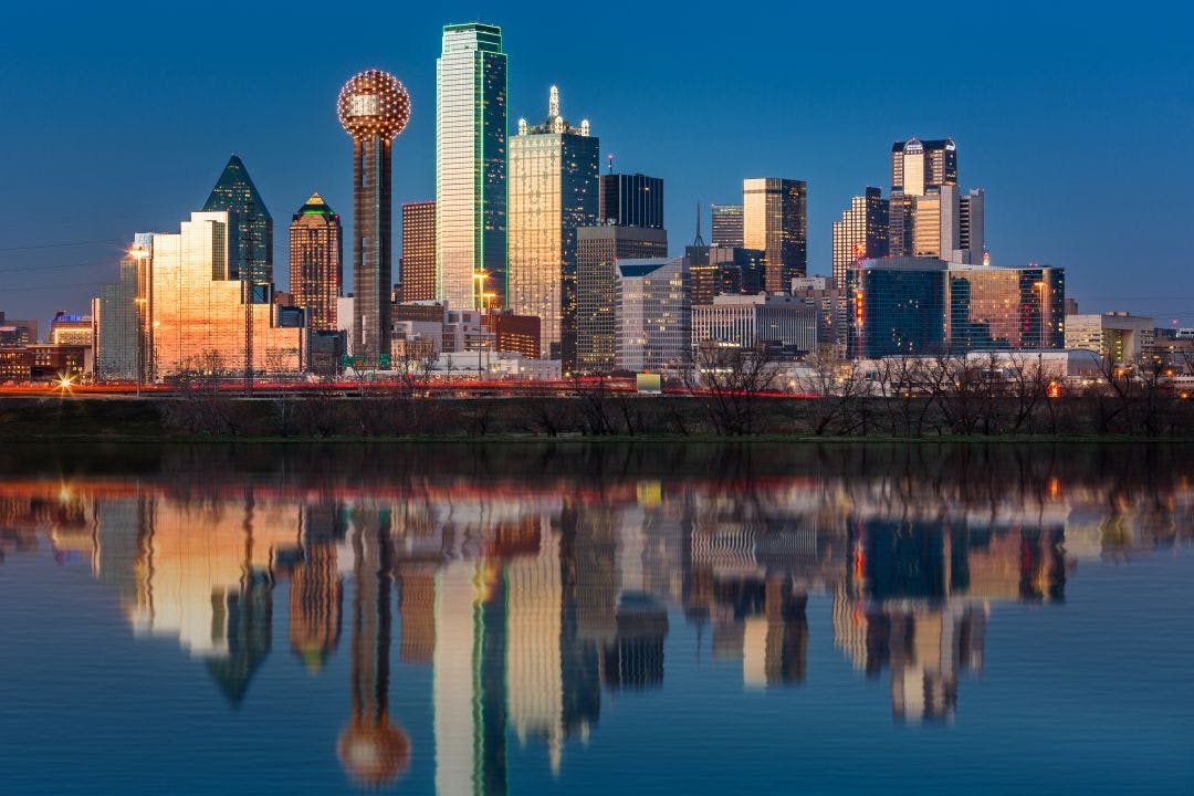 Dallas skyline reflected in Trinity River at sunset Dallas Indian Motorcycle Rentals on Riders Share