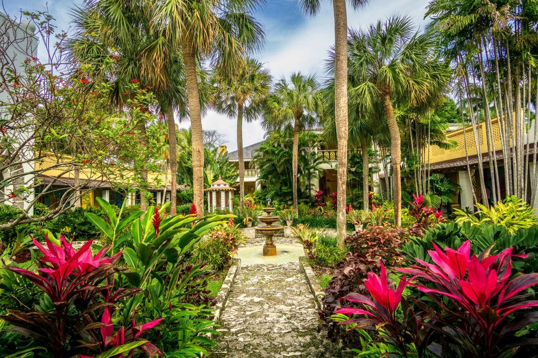 Landscape view of courtyard and fountain at the Bonnet House, a historic house museum standing amidst a lush tropical paradise Discover Things to Do in Fort Lauderdale, FL