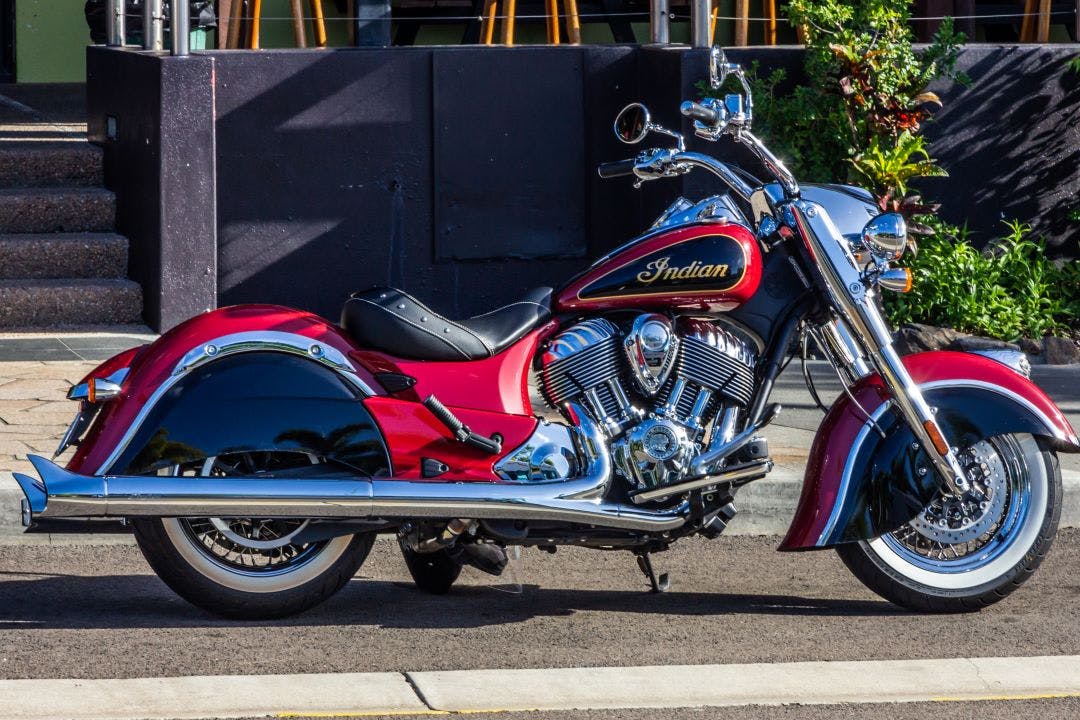 picture of an indian chief motorcycle parked on a sidewalk comparison of indian scout vs. indian chief motorcycles
