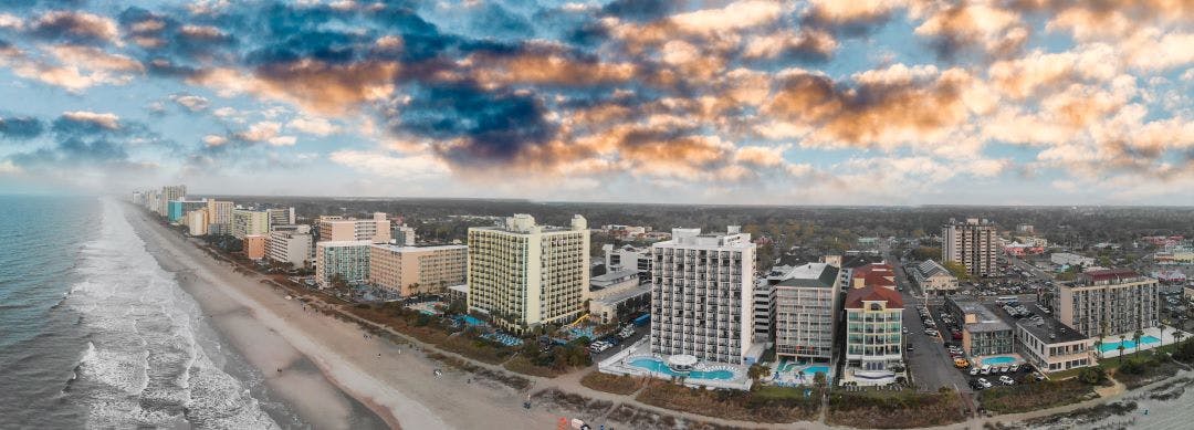 feature aerial panoramic view of Myrtle Beach skyline and coastline at sunset Myrtle Beach bike week info