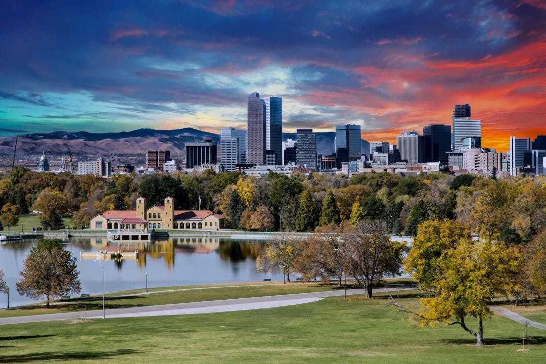 denver skyline and mountains beyond lake motorcycle events in colorado