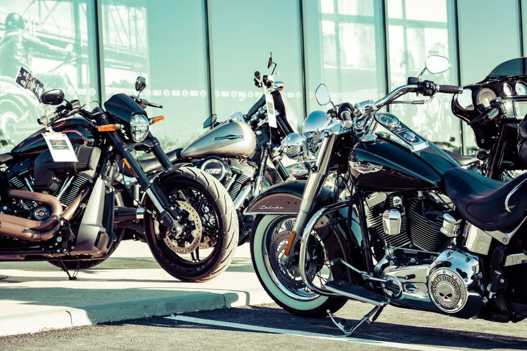 close up of modern harley davidson motorcycles parked in front of a dealer What's High Mileage for a Harley-Davidson Motorcycle?