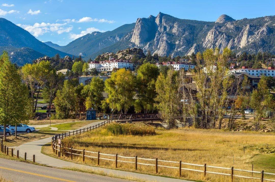 estes park in autumn with the stanley hotel and rocky mountains in the background Your Colorado Motorcycle Adventures Await 