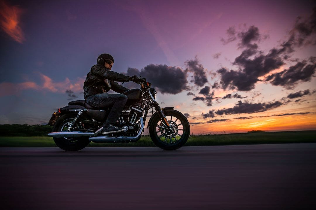 man riding motorcycle at sunset What Hazards Might a Motorcyclist Encounter on the Road?