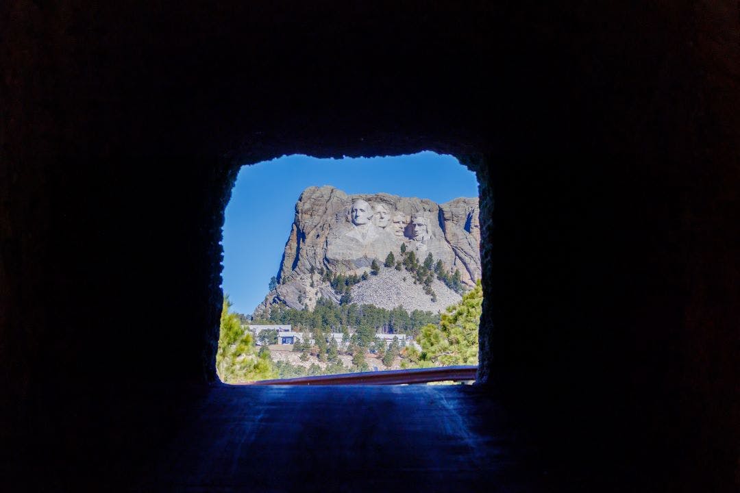 View of Mount Rushmore through Doane Robinson tunnel on the Iron Mount Road near Keystone South Dakota Best South Dakota Motorcycle Rides