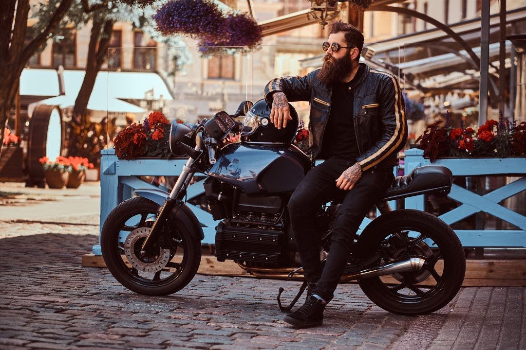 man on motorcycle sitting outside motorcycle coffee shop Coolest Motorcycle Coffee Shops in the USA