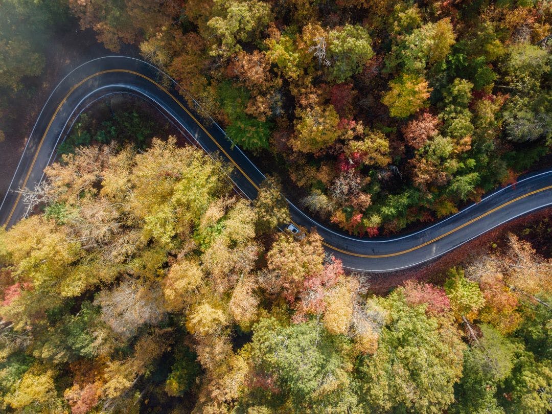 Aerial View of the Tail of the Dragon road near the Tennessee and North Carolina border in the Smoky Mountains in the Fall Top Destinations for Motorcycle Rentals in 2024-2025