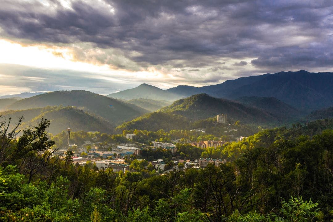 Sunrise Over Gatlinburg, Tennessee. Misty morning sunrise over the mountain resort town of Gatlinburg Tennessee Best Motorcycle Rides in the Great Smoky Mountains