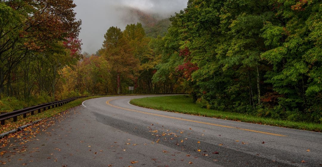 The fall colors on the Cherohala Skyway as the road curves Best Motorcycle Rides in the Great Smoky Mountains