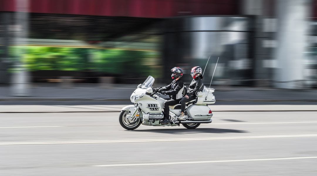 Honda Gold Wing GL1800 motorcycle with rider driving on high speed History of the Honda Gold Wing Motorcycle