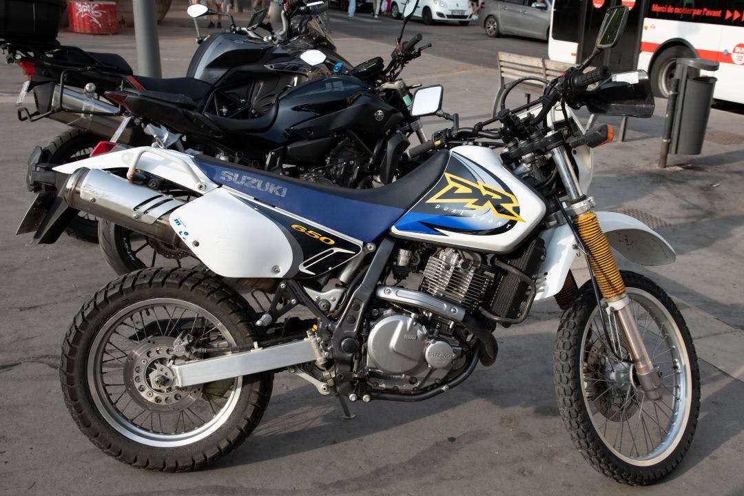 Suzuki dr 650 dual sport motorcycle vintage retro motorbike trail parked in street What Exactly is a Dual Sport Bike