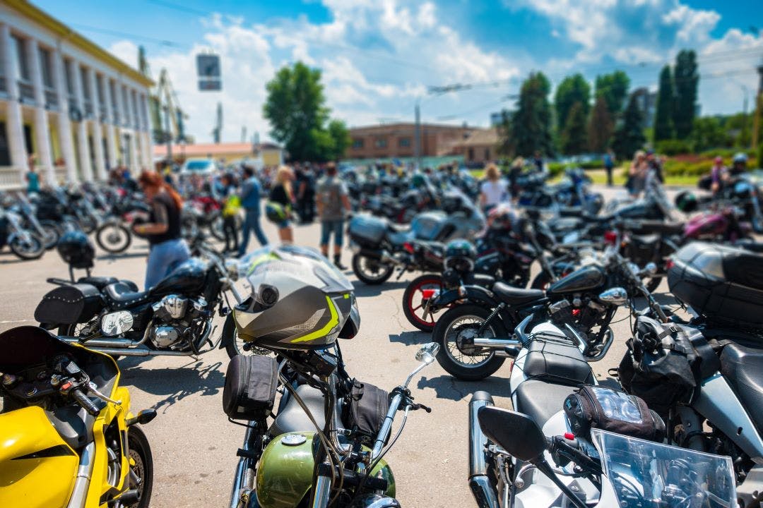 Congress of bikers. Many motorcycles in the square Your Complete Guide to Group Riding: Etiquette, Signals, & More