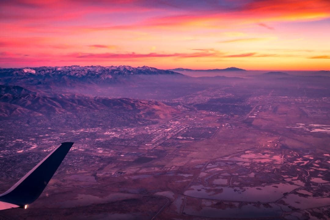 flying over rockies in airplane from salt lake city at sunset What's There To Do In Salt Lake City, Utah?