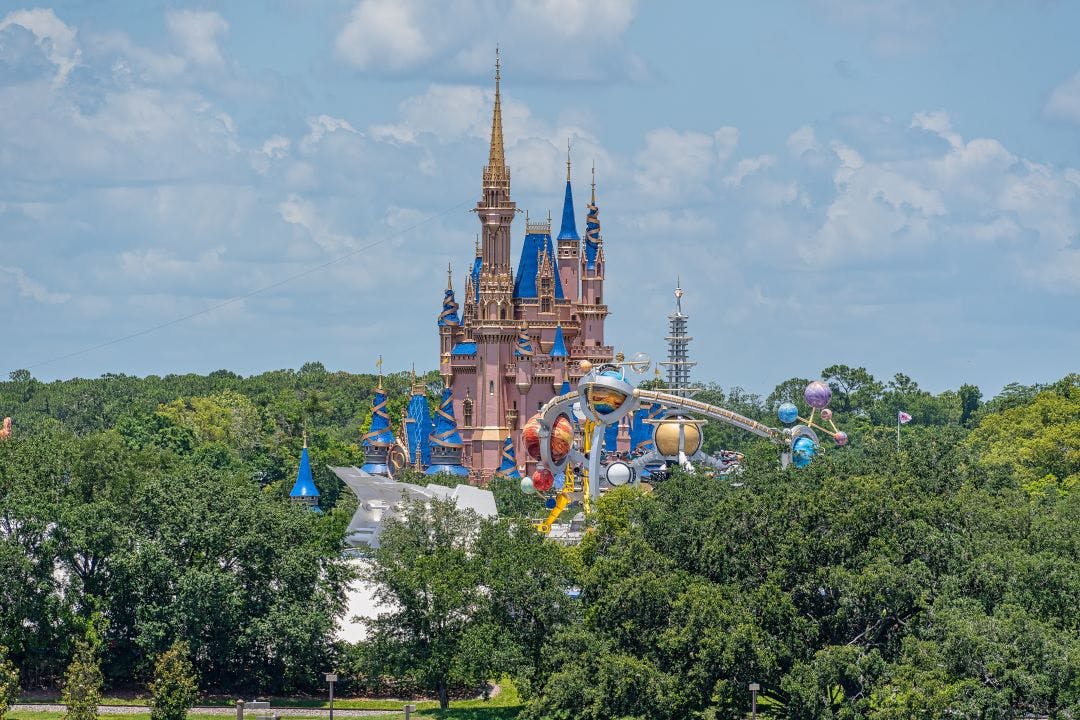 Cinderella Castle at Disney World appearing from the trees 13 Day Trips to-and-from Daytona Beach