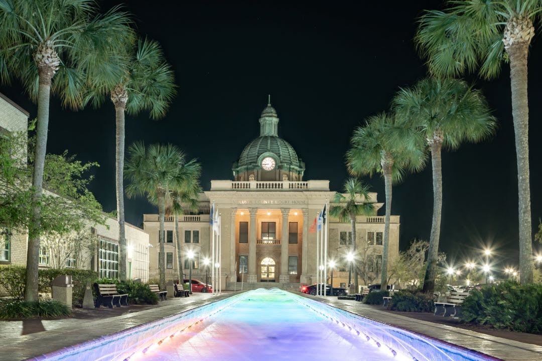 evening photo of the historic Volusia County Courthouse and fountain pool in DeLand, Florida 13 Day Trips to-and-from Daytona Beach