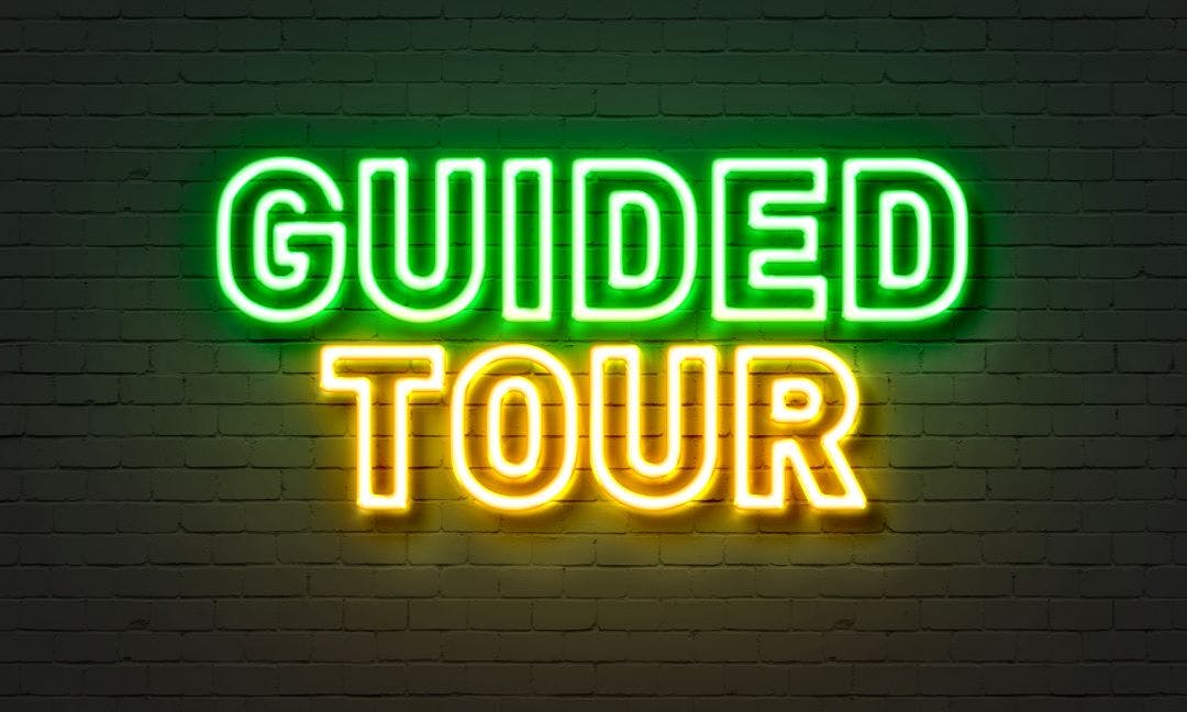 Guided tour neon sign on brick wall background Choosing a Guided Motorcycle Tour that Matches Your Speed