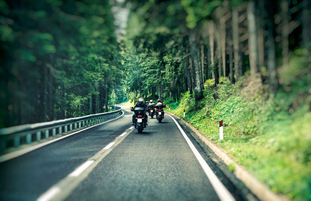 Group of bikers on the highway What Nobody Tells You About Motorcycle Travel