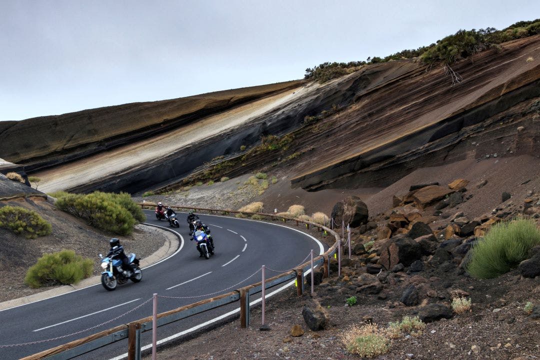 group of motorbikers on a mountain road Guided vs. Self-Guided Motorcycle Tours: Pros & Cons