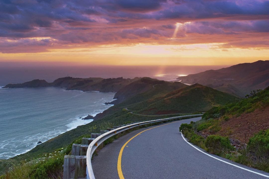 Beautiful colorful sunset viewed from the coastal road, pacific coast near San Francisco, United States of America 10 Most Memorable Self-Guided Motorcycle Tours in the USA