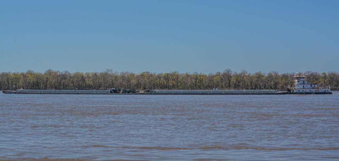 A Tug Boat is pushing Barges down the Mississippi River 13 Scenic Locations to See Autumn Foliage in Tennessee